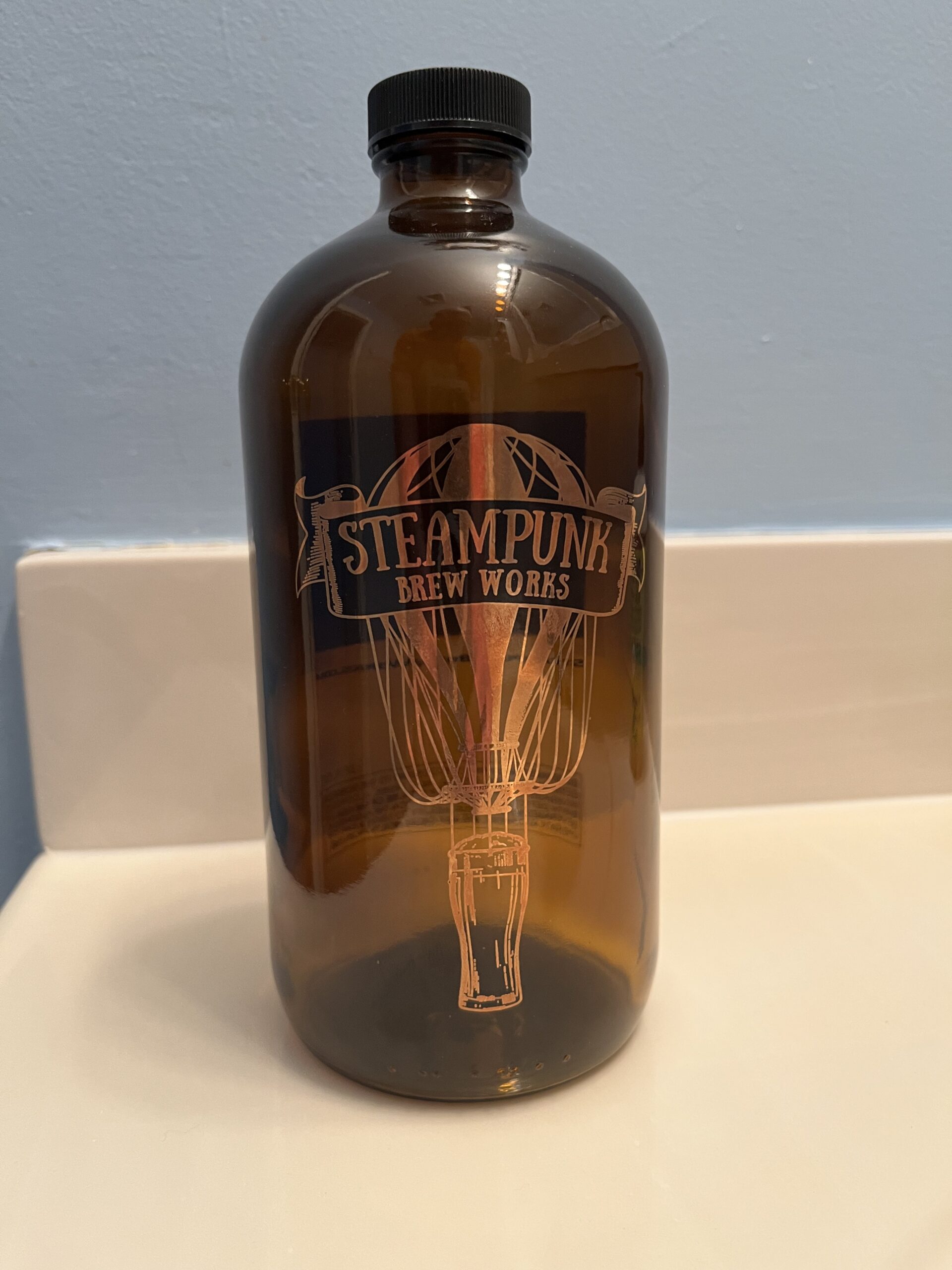 Item FW 3 - One glass, 32 oz Growler bottle ready to fill with Free Beer from Steampunk Brew Works valued at $15